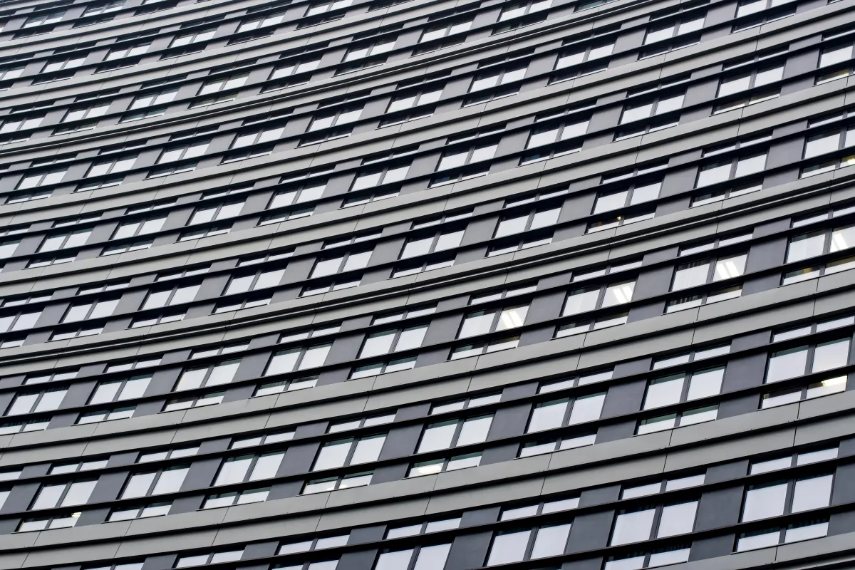 Dark patterned office facade with staggered windows
